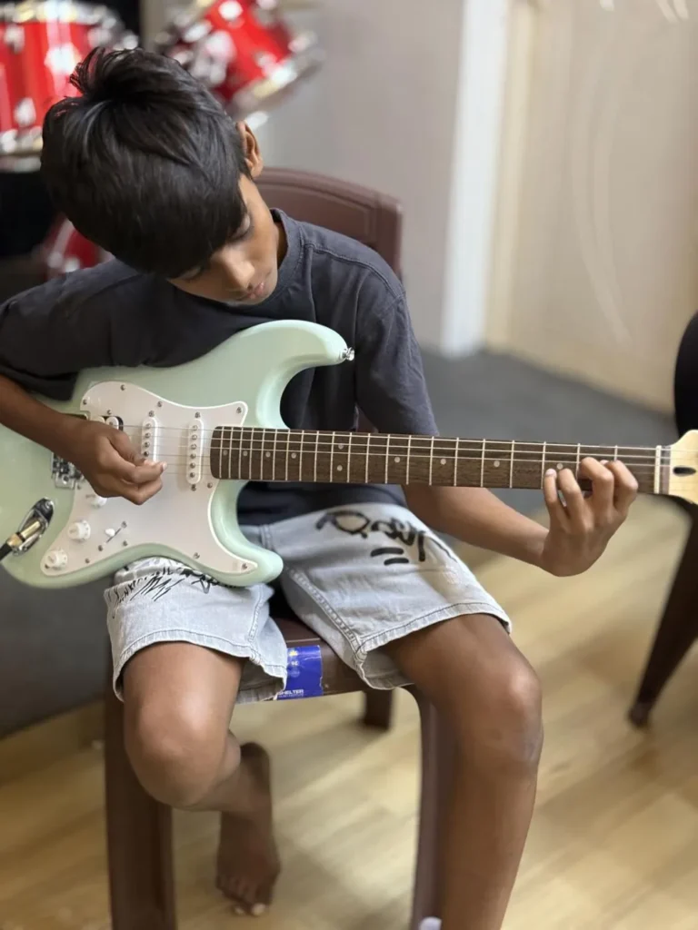 A boy playing electric guitar