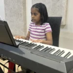 A girl practising on a digital piano