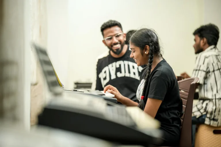 Founder Sabi Thankachan teaching a student at the keyboard