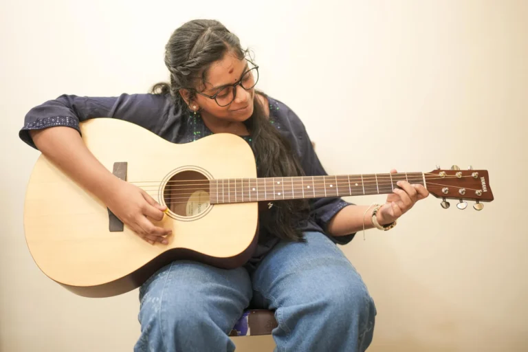 A student practising acoustic guitar